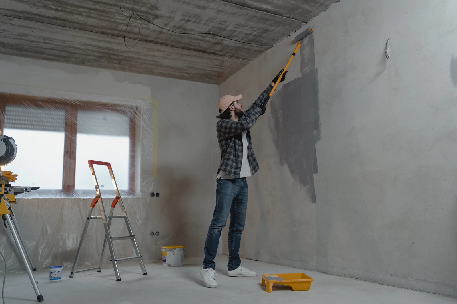Artisan peintre appliquant une peinture intérieure au rouleau